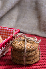 Savory cookies sprinkled with sesame seeds, sunflower on red table
