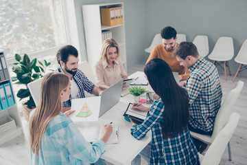 Busy financiers sitting at desk typing on keypad organizing day writing notes, using tablet,...