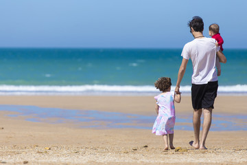 Dad and daughters in the beach