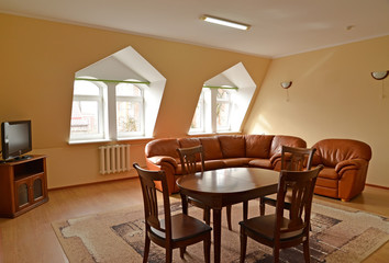 Living room interior with brown furniture and a leather sofa and a chair