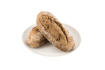 bread with cereals and nuts in a plate on white background