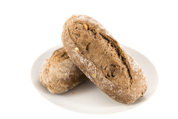 bread with cereals and nuts in a plate on white background