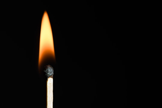 The match on fire on black background close-up