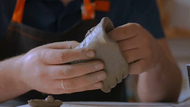Clay workshop: man making mug in pottery studio. Handmade, art and study concept