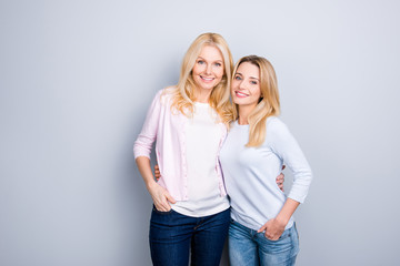 Portrait of attractive charming pretty cute similar mother and daughter embracing holding hands in...