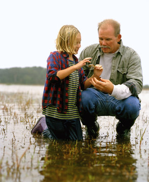 Father and daughter in marshland