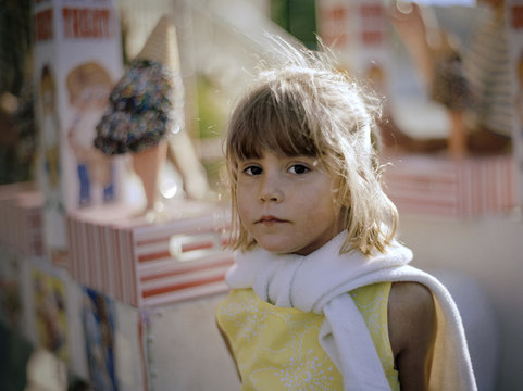 Portrait of a young girl standing next to an ice cream truck.