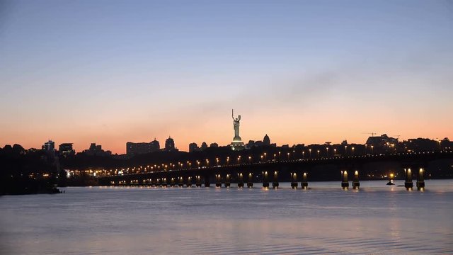 Sunset Timelapse of Right Bank of Kiev, Ukraine and Road Bridge - Paton Bridge above the River Dnepr at Night. 4K Ultra HD 