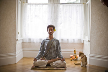 Portrait of man practicing yoga at home