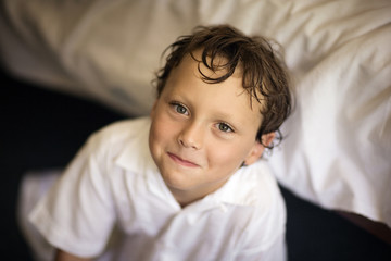 Portrait of smiling boy sitting at home