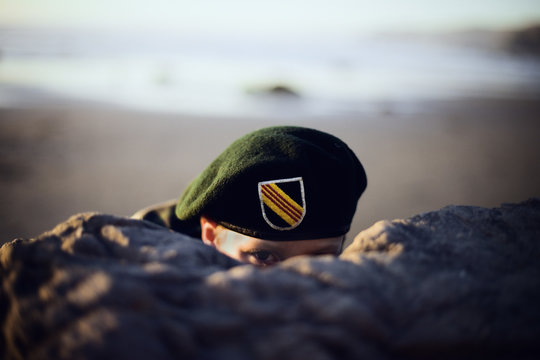 army Luke hiding behind rock