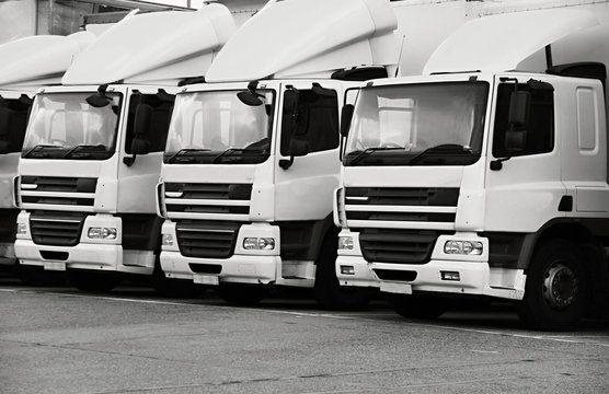 lorries parked up outside a company's car parking area ready to deliver goods to customers stock photo