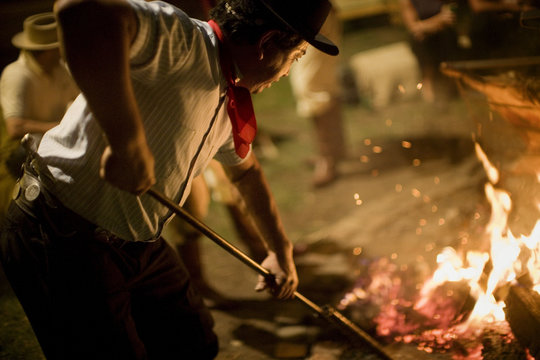 A man is stoking fire.