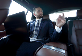 Confident businessman talking in car