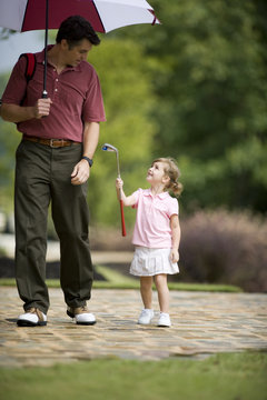 Father and daughter on golf course