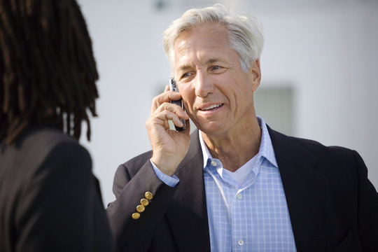 Mature businessman talking on a cell phone.