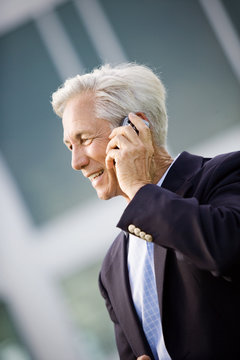 Mature businessman talking on a cell phone.