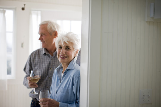 Portrait of a senior woman drinking wine with her husband.