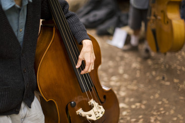 Chello being held by a musician.