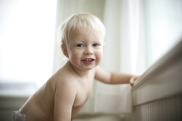 Portrait of a happy young toddler indoors.
