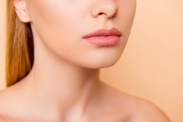 Obraz na płótnie Canvas Close up cropped half face portrait of attractive, nude, natural, perfect, ideal girl with soft, healthy smooth lips isolated on beige background, perfection, wellness, wellbeing concept