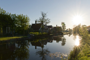 Fototapeta na wymiar Reflecting sun in a river in Zaanse Schans, The Netherlands