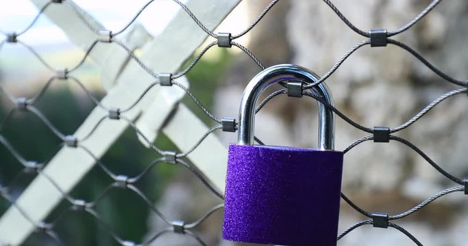 Padlock attached to grid. Love lock attached to bridge