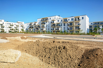 Urban development with construction site and new residential buildings