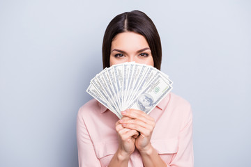Portrait of pretty charming positive glad funny woman covering closing half face with fan from dollars looking out with eyes at camera isolated on grey background