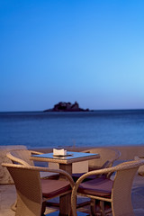 Restaurant table at a seaside resort at dusk