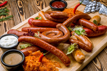 assorted sausages with sauces