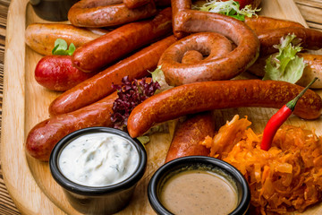 assorted sausages with sauces