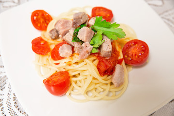 Spaghetti with sauce of Mediterranean tuna, Italian extra virgin olive oil, pepper, cherry tomatoes and a sprinkling of parsley
