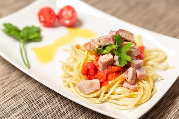 Spaghetti with sauce of Mediterranean tuna, Italian extra virgin olive oil, pepper, cherry tomatoes and a sprinkling of parsley