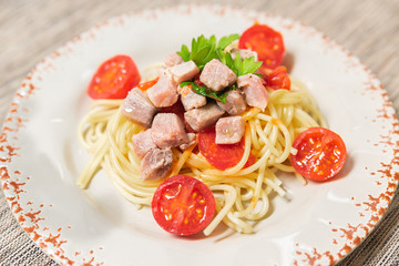 Spaghetti with sauce of Mediterranean tuna, Italian extra virgin olive oil, pepper, cherry tomatoes and a sprinkling of parsley