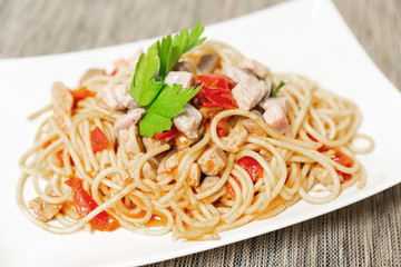 Spaghetti with sauce of Mediterranean tuna, Italian extra virgin olive oil, pepper, cherry tomatoes and a sprinkling of parsley