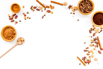 Seasoning for cooking desserts. Cinnamon, cocoa, badian, coffee, sugar on white background top view copy space