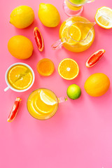 Brew fruit tea. Teacup and teapot near orange, lime, lemon, grapefruit on pink background top view space for text