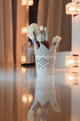 makeup brushes set on a white table