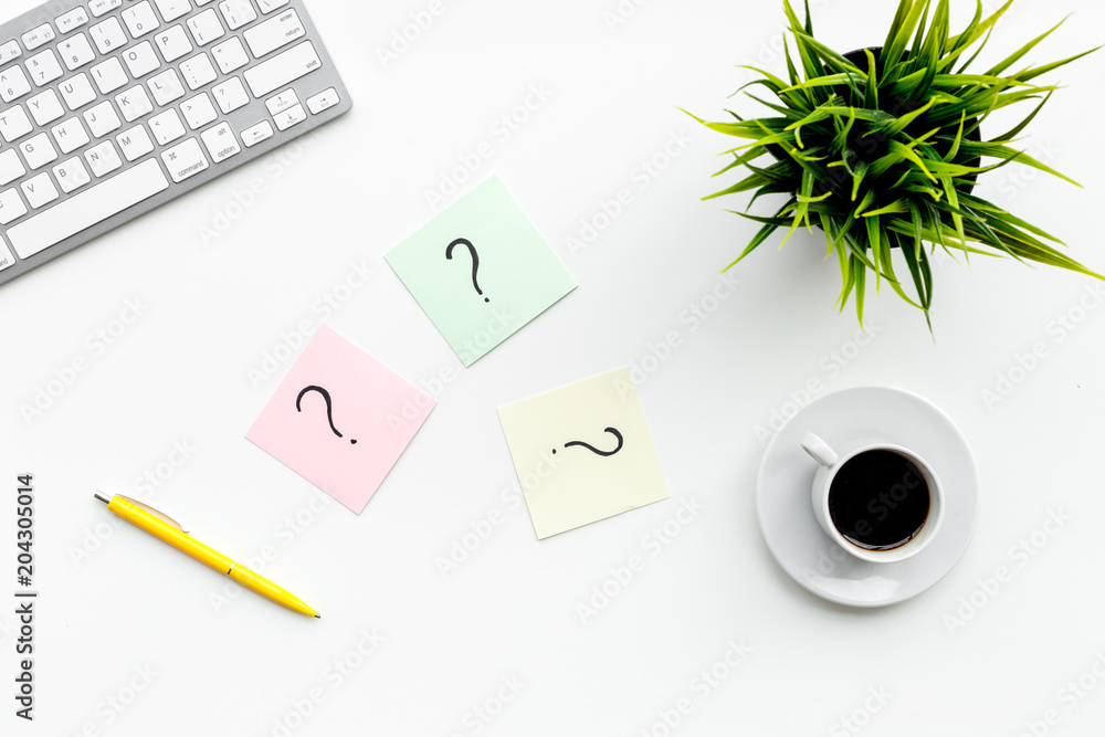 Poster question mark on sticky notes on office desk on white background top view. faq concept. working with