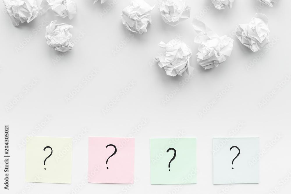 Poster faq concept. question mark on sticky notes near crumpled paper on white background top view copy spa