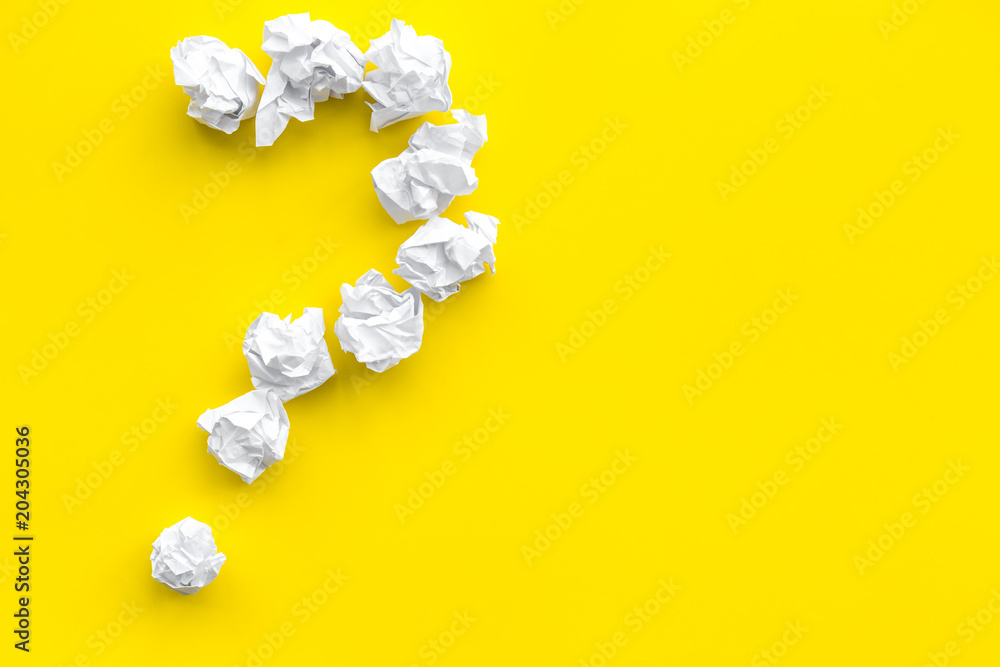 Poster question mark lined with crumpled paper on yellow background top view copy space