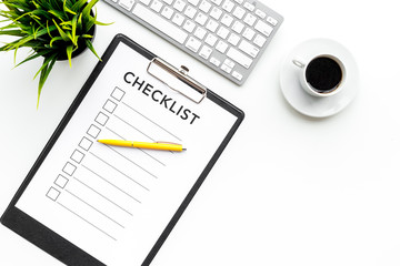 Blank checklist with space for ticks on pad on office desk. Checklist for office worker, manager, businessman, chief on white background top view space for text