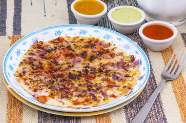 South Indian Food Uttapam Also Know As ooththappam, Rava Uttapam, Uttapa or Uthappa is a Popular South Indian Delicious Spicy Breakfast Snack Served with Coconut Chutney, Tomato Sauce and Sambar