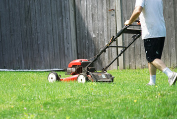 Fototapeta na wymiar outdoor worker working on mowing the lawn