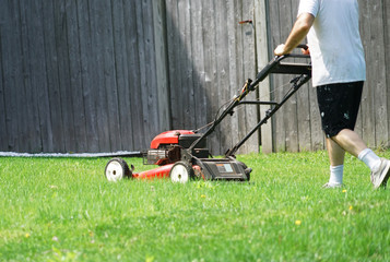 outdoor worker working on mowing the lawn