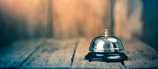 Bell metal service on wood ground with blurred wooden background. Panorama crop size - obrazy, fototapety, plakaty