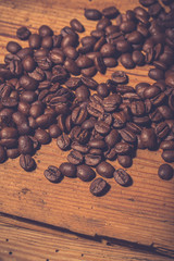 Coffee beans on old wooden table. Vintage style