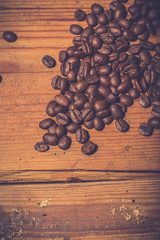 Coffee beans on old wooden table. Vintage style