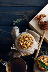 A fragrant flower tea with delicious cookies on the dark table